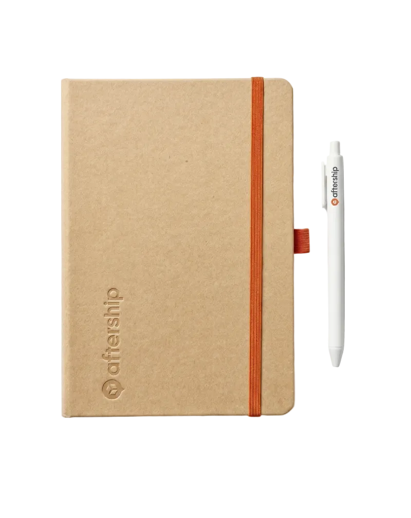 Kraft paper notebook with orange strap and pen on a white background